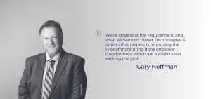 A man in a suit stands next to a quote by Gary Hoffman.