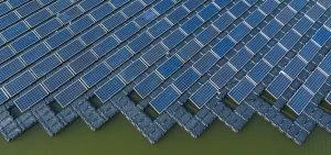 Rows of blue solar panels float on a body of water.