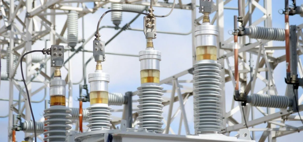 Electrical insulators stand in an outdoor substation.