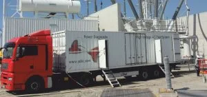 A red truck pulls a white trailer labeled Power Diagnstix.