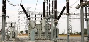 Electrical substation equipment stands in an outdoor field.