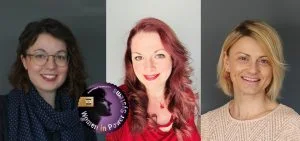 Three women smile against a plain background.