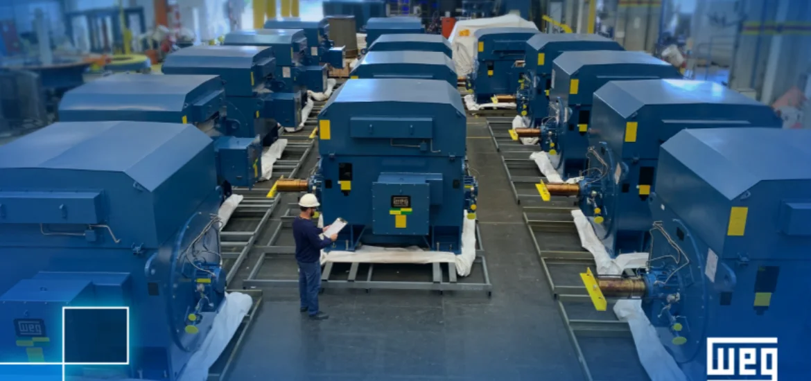 Rows of large blue industrial machines sit on metal frames in a warehouse.