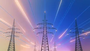 Power lines stretch across a gradient sky between several electricity pylons.