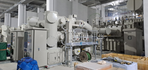 High-voltage electrical switchgear and transformer equipment at a power substation.