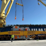 Heavy-lift vessel cranes and specialized transport equipment at the Port of Motril during Hitachi Energy's 425 MVA transformer export operation.